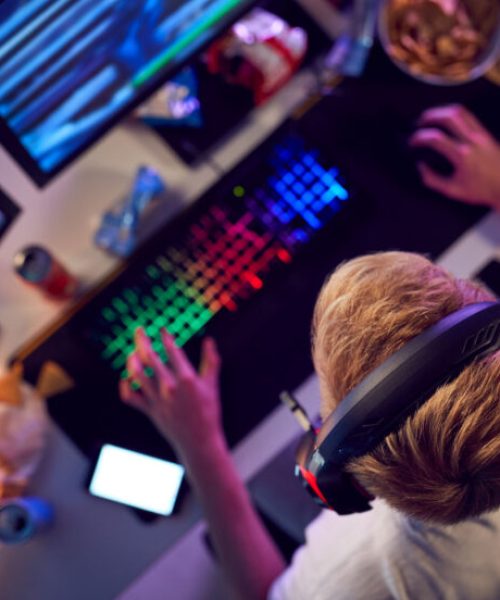 overhead-view-of-teenage-hacker-sitting-in-front-o-2021-08-27-09-16-43-utc-800x552